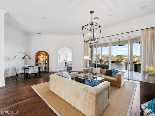 living room with crown molding, a chandelier, and dark hardwood / wood-style flooring