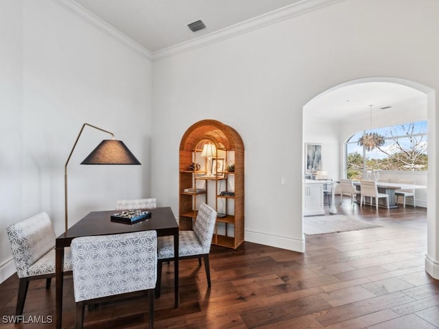 dining room with crown molding and dark wood-type flooring