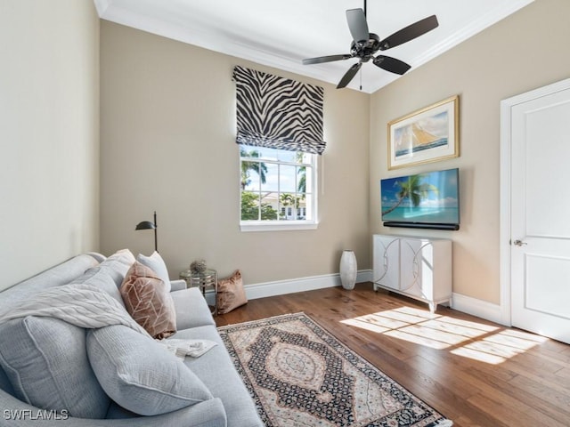 living room featuring crown molding, hardwood / wood-style floors, and ceiling fan