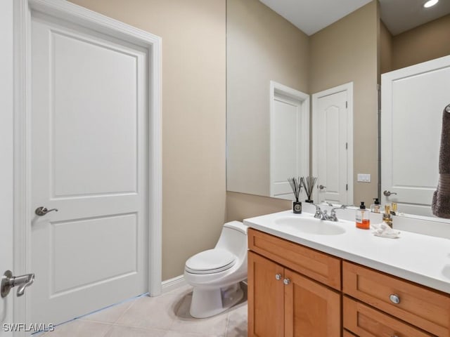 bathroom with vanity, tile patterned flooring, and toilet