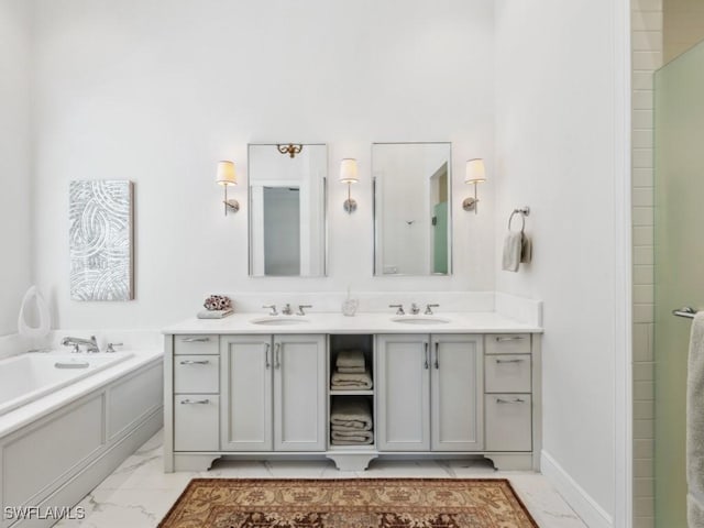 bathroom with vanity and a tub