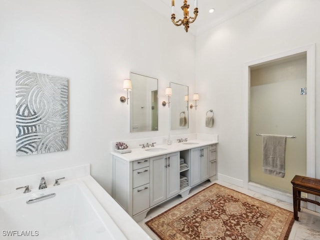 bathroom with a chandelier, a towering ceiling, vanity, and a bathing tub