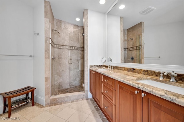 bathroom with tile patterned flooring, vanity, and a shower with shower door