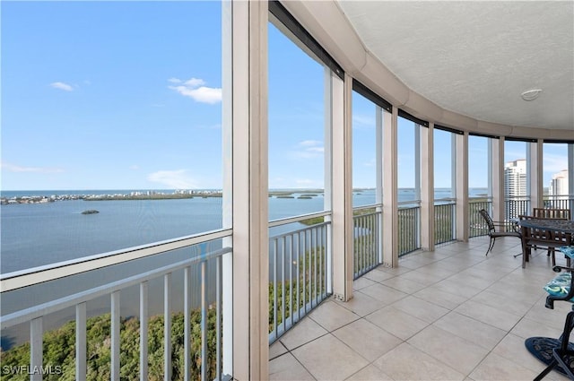 sunroom / solarium with a water view