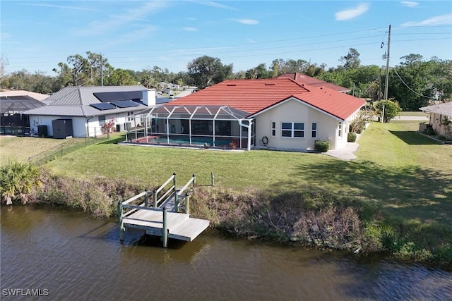 back of property featuring a lawn, a lanai, a water view, and a swimming pool