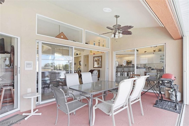 sunroom / solarium with ceiling fan and vaulted ceiling