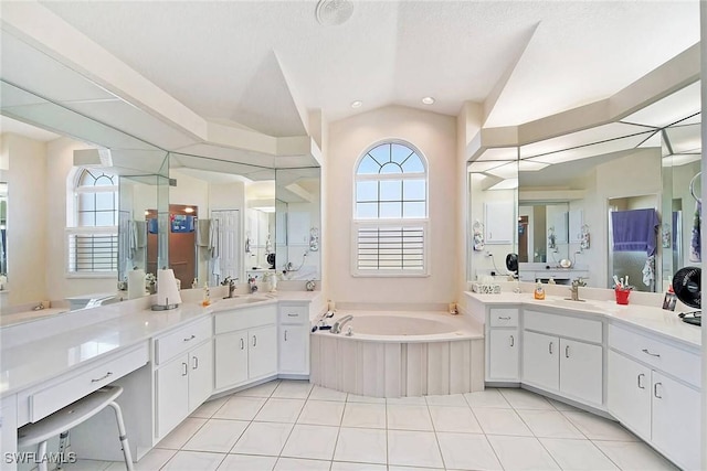 bathroom with tile patterned flooring, vanity, a textured ceiling, and vaulted ceiling