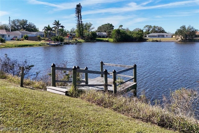 dock area featuring a water view and a yard