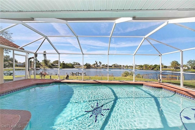 view of pool with glass enclosure and a water view