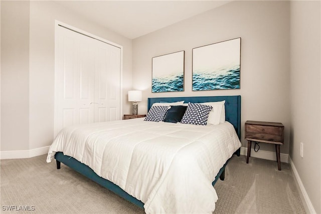 bedroom with light colored carpet and a closet