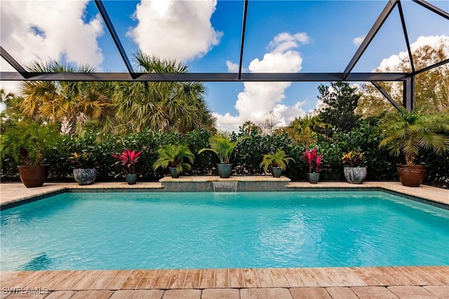 view of swimming pool featuring a lanai