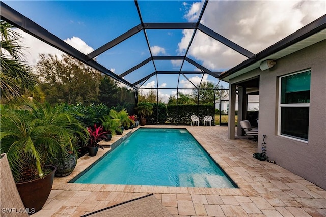 view of pool featuring a lanai and a patio area