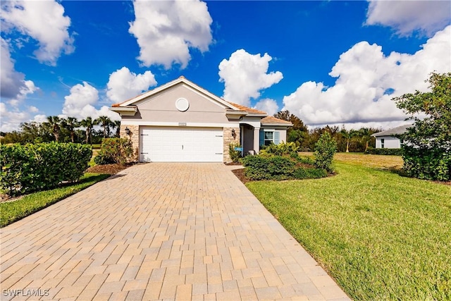 view of front of house with a garage and a front lawn