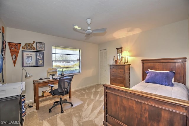 bedroom featuring light carpet, a closet, and ceiling fan