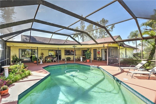 view of swimming pool with a patio and glass enclosure