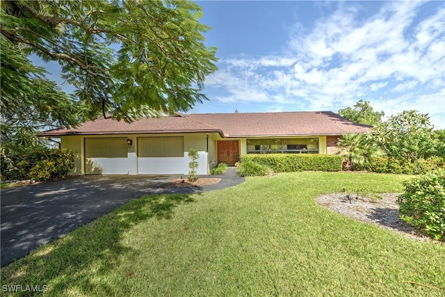 ranch-style house with a front yard and a garage