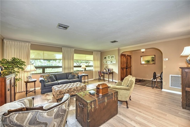 living room with light wood-type flooring and ornamental molding