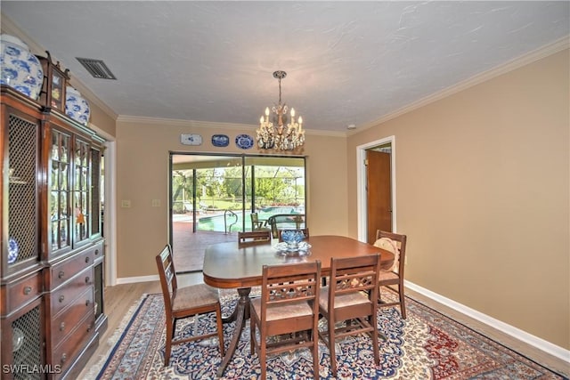 dining area with a chandelier, light hardwood / wood-style floors, and ornamental molding