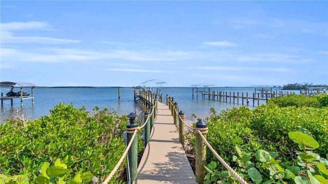 dock area with a water view and boat lift