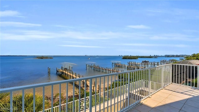 balcony featuring a water view and a dock