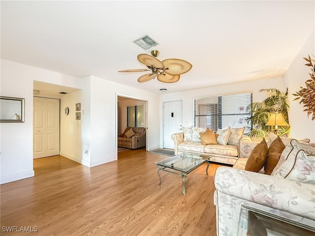 living room with hardwood / wood-style flooring and ceiling fan