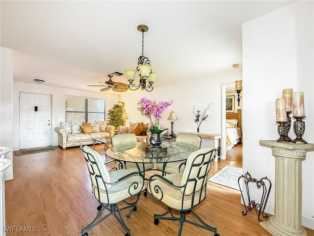 13276 White Marsh Ln Unit 3524, Fort Myers, FL 33912 - dining space featuring a chandelier and wood finished floors