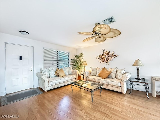 living room with ceiling fan and light wood-type flooring