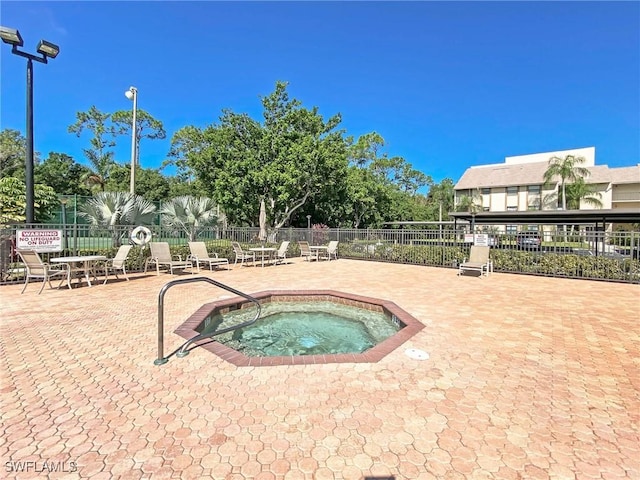 view of pool featuring a patio and a hot tub