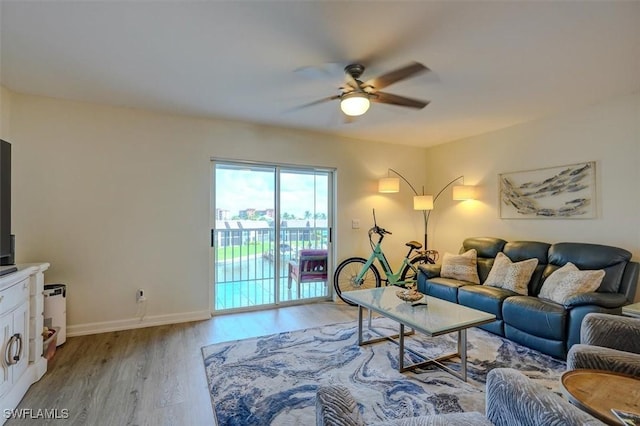 living room featuring ceiling fan and light wood-type flooring