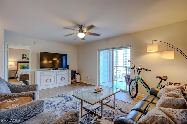 living room featuring light hardwood / wood-style floors and ceiling fan