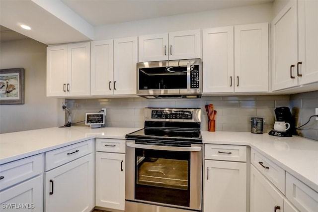 kitchen featuring decorative backsplash, white cabinetry, and stainless steel appliances