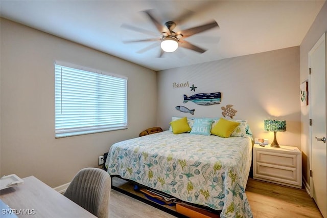 bedroom with ceiling fan and light hardwood / wood-style floors