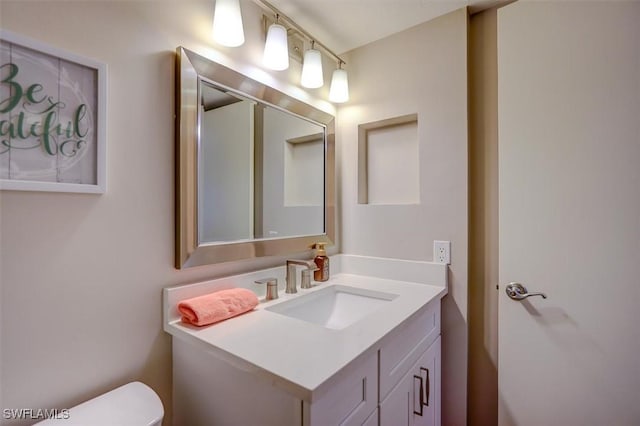 bathroom featuring vanity and toilet