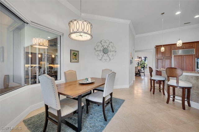 tiled dining space featuring crown molding