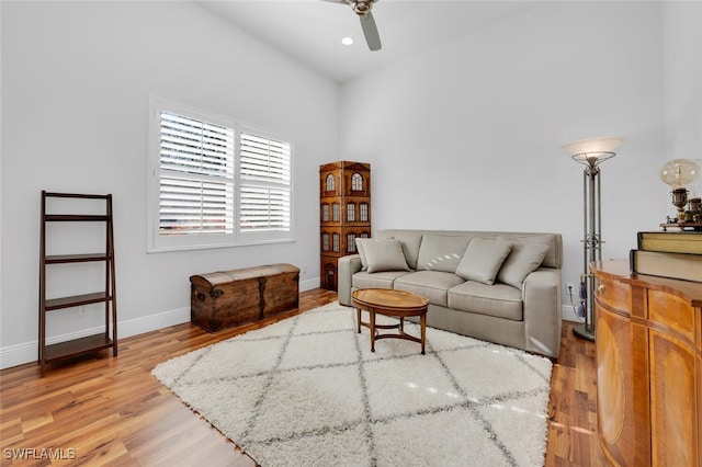 living room featuring light hardwood / wood-style flooring and ceiling fan