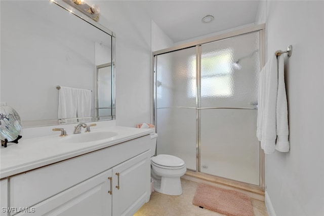 bathroom with vanity, toilet, and an enclosed shower