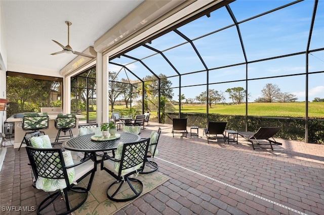 view of patio / terrace with glass enclosure and ceiling fan