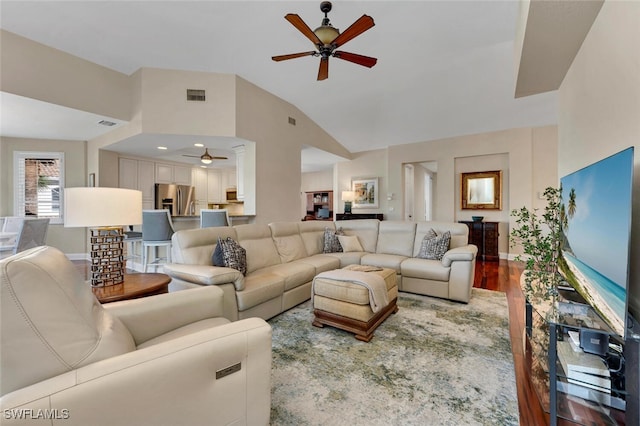 living room with vaulted ceiling, ceiling fan, and hardwood / wood-style flooring