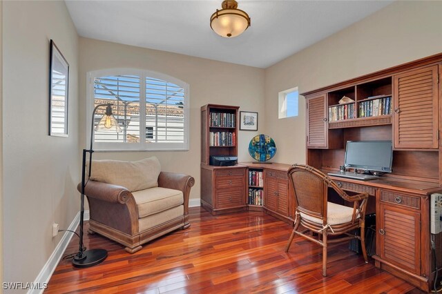 office with a healthy amount of sunlight and dark wood-type flooring