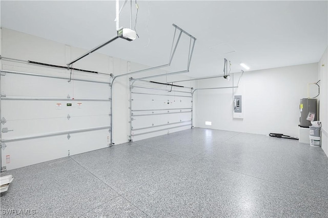 garage with a garage door opener, electric water heater, and electric panel