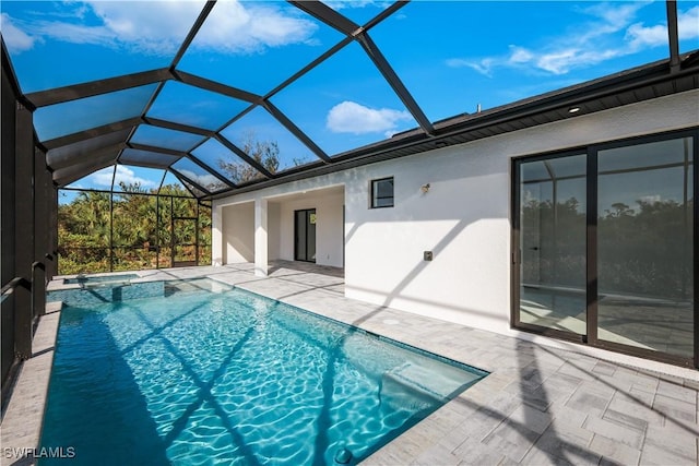 view of swimming pool featuring glass enclosure and a patio area