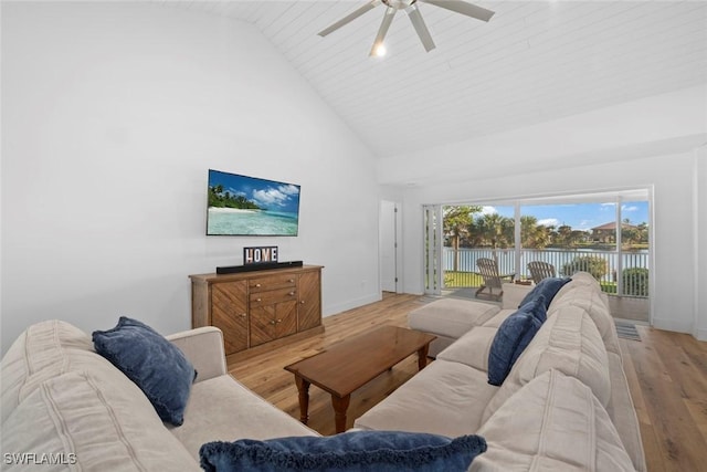 living room with light wood-type flooring, high vaulted ceiling, and ceiling fan