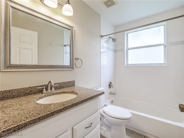 full bathroom featuring vanity, toilet, and tiled shower / bath