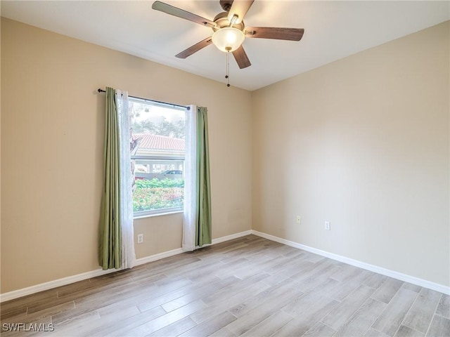 empty room featuring ceiling fan and light hardwood / wood-style floors