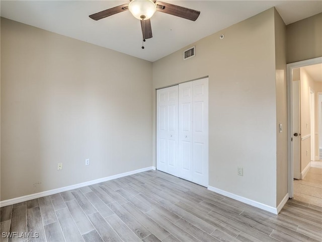 unfurnished bedroom with ceiling fan, a closet, and light hardwood / wood-style floors