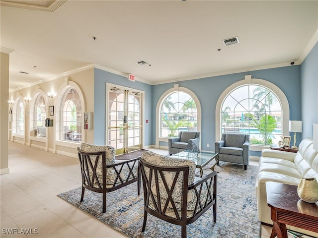 living room with a wealth of natural light, french doors, light tile patterned floors, and ornamental molding