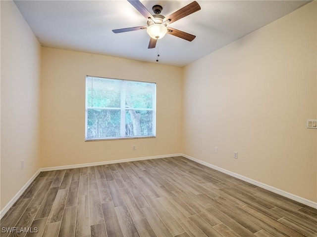 spare room featuring ceiling fan and light wood-type flooring