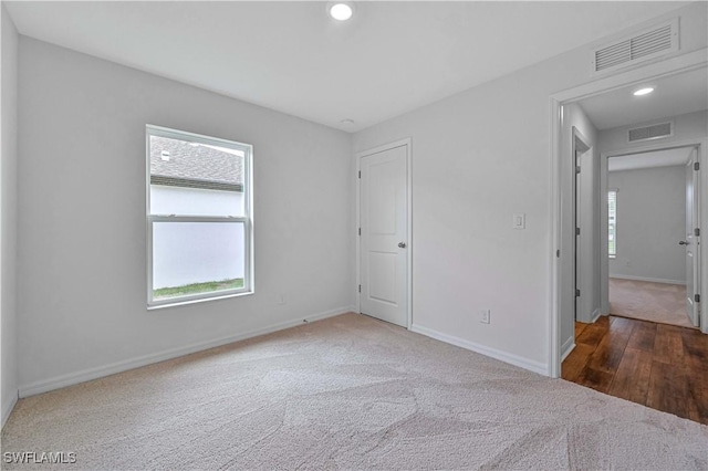 spare room featuring dark hardwood / wood-style flooring