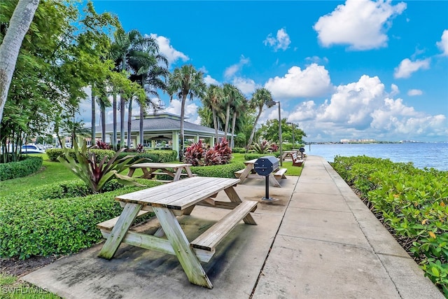 view of community with a water view and a patio