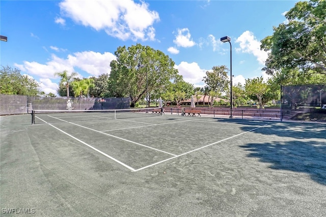 view of tennis court with fence